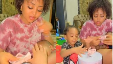 See cash wey we dey find – Backlashes trail video of Regina Daniels and sons putting wraps of money in piggy bank