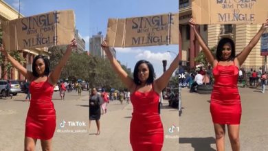 “Who’s my guy?” – Lady in red gown takes placard to street, says she’s ready to mingle [Video]